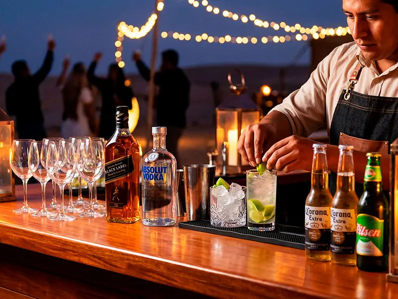 Barra libre premium con licores de marca y coctelería de autor en campamento de lujo