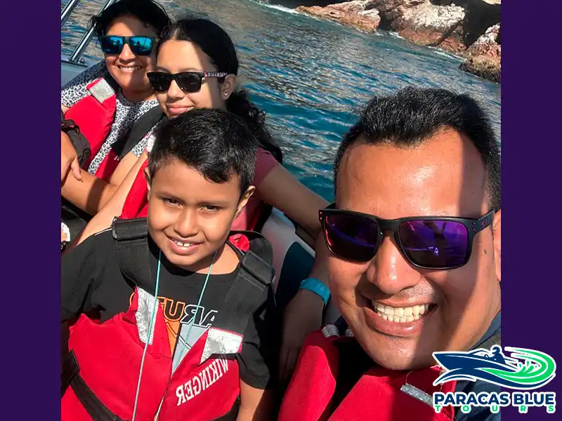 Familia disfrutando del tour a las Islas Ballestas en Paracas durante un paseo en lancha con Paracas Blue Tours
